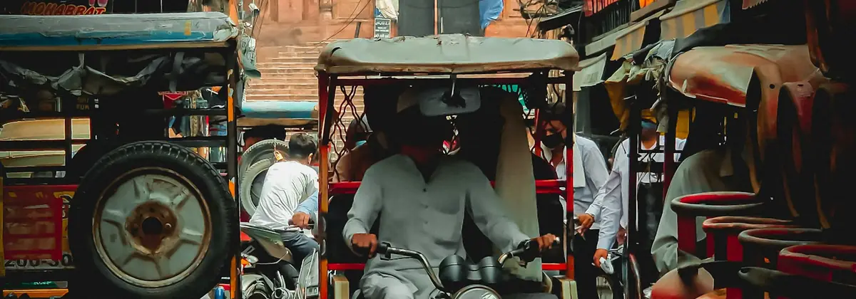 An auto-rickshaw driver on an Indian street