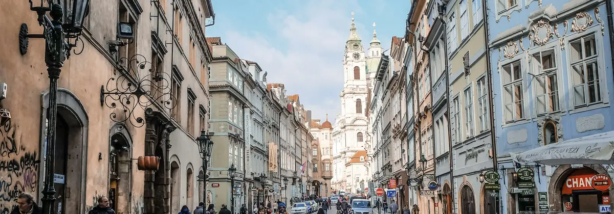Visitors strolling a cobbled European old-town street