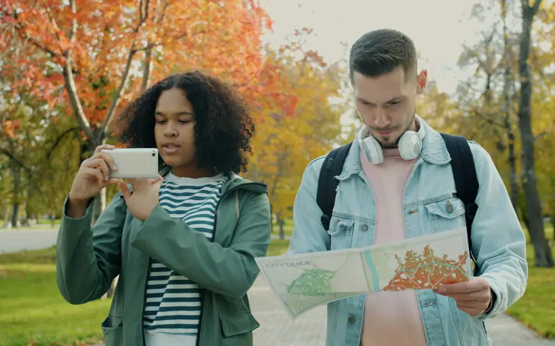 Two travellers looking at a map, choosing where to go